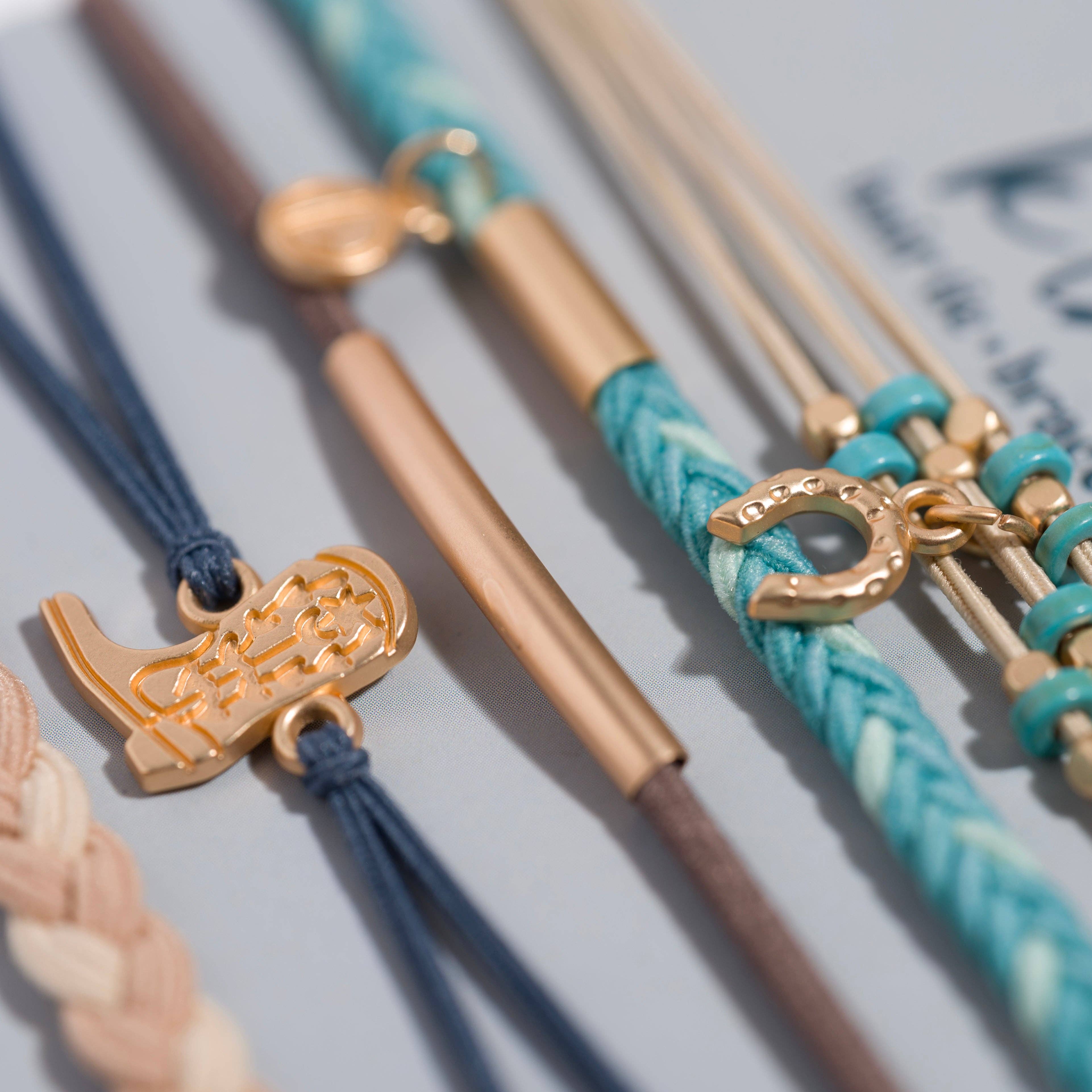 Stride hair tie bracelet set in blue, brown, cream and teal with gold cowboy boot and horseshoe charms, view 3
