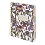 Spiral-bound art journal with a painted iris cover, detail view