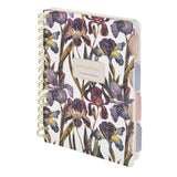 Spiral-bound art journal with a painted iris cover, detail view