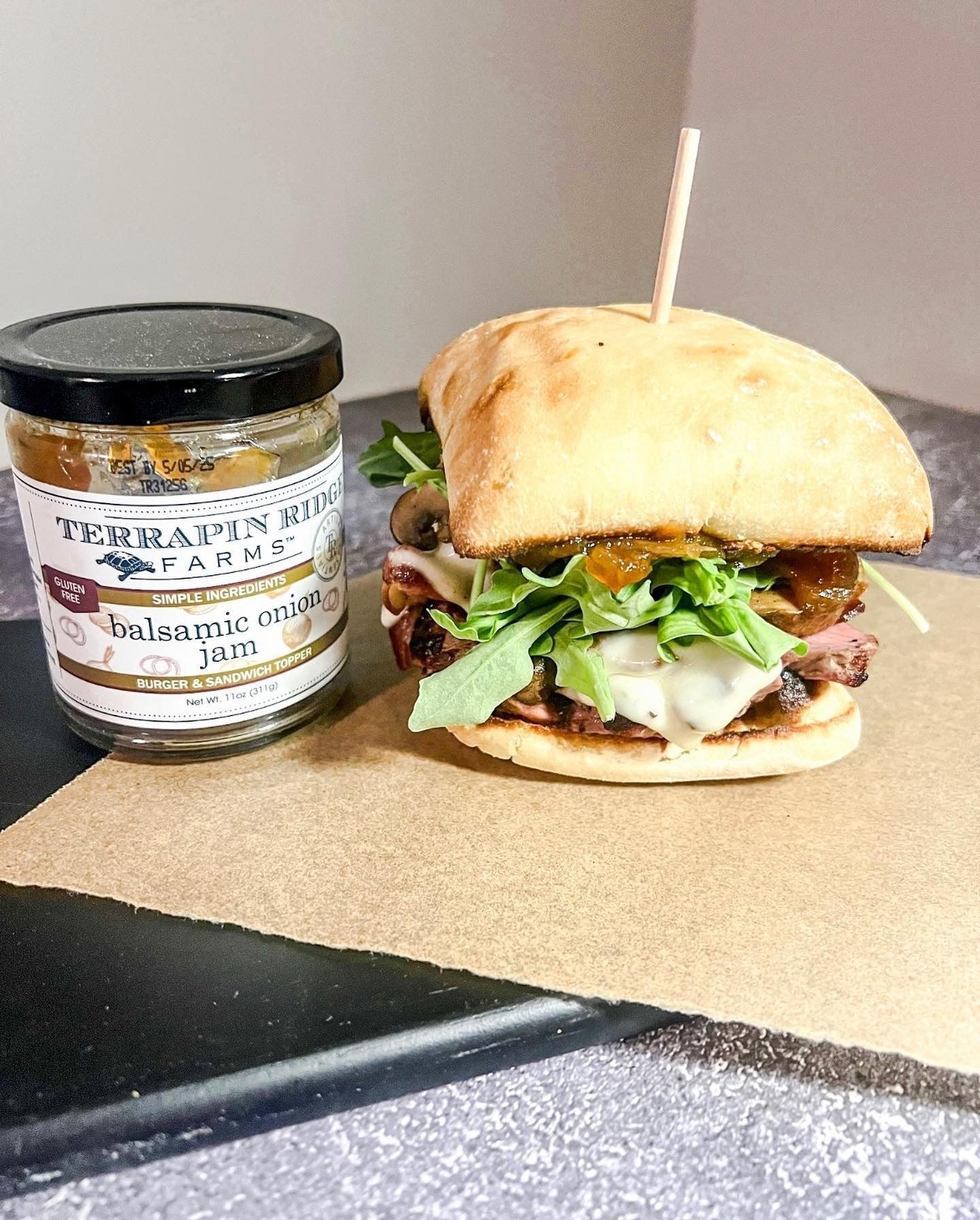 Ciabatta sandwich with arugula, melted cheese and Balsamic Onion Jam