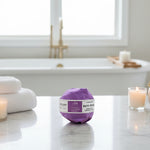 Purple bath bomb with a label on a white background