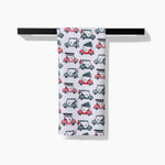 Holiday golf tea towel draped over a towel bar