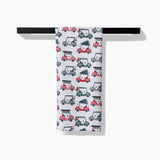 Holiday golf tea towel draped over a towel bar