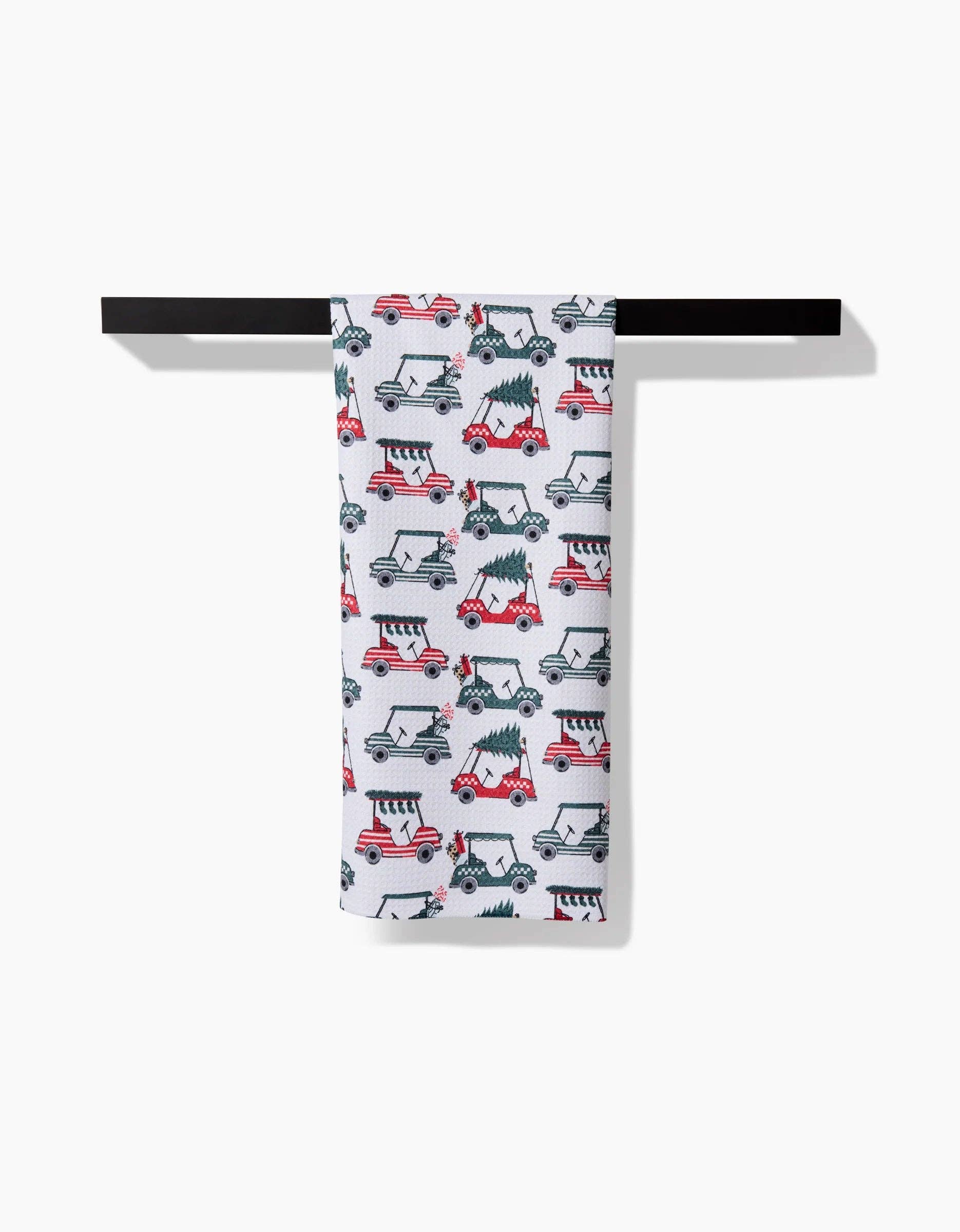 Holiday golf tea towel draped over a towel bar