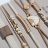 Rise hair tie bracelet set in cream and tan with gold sunrise charm, view 3