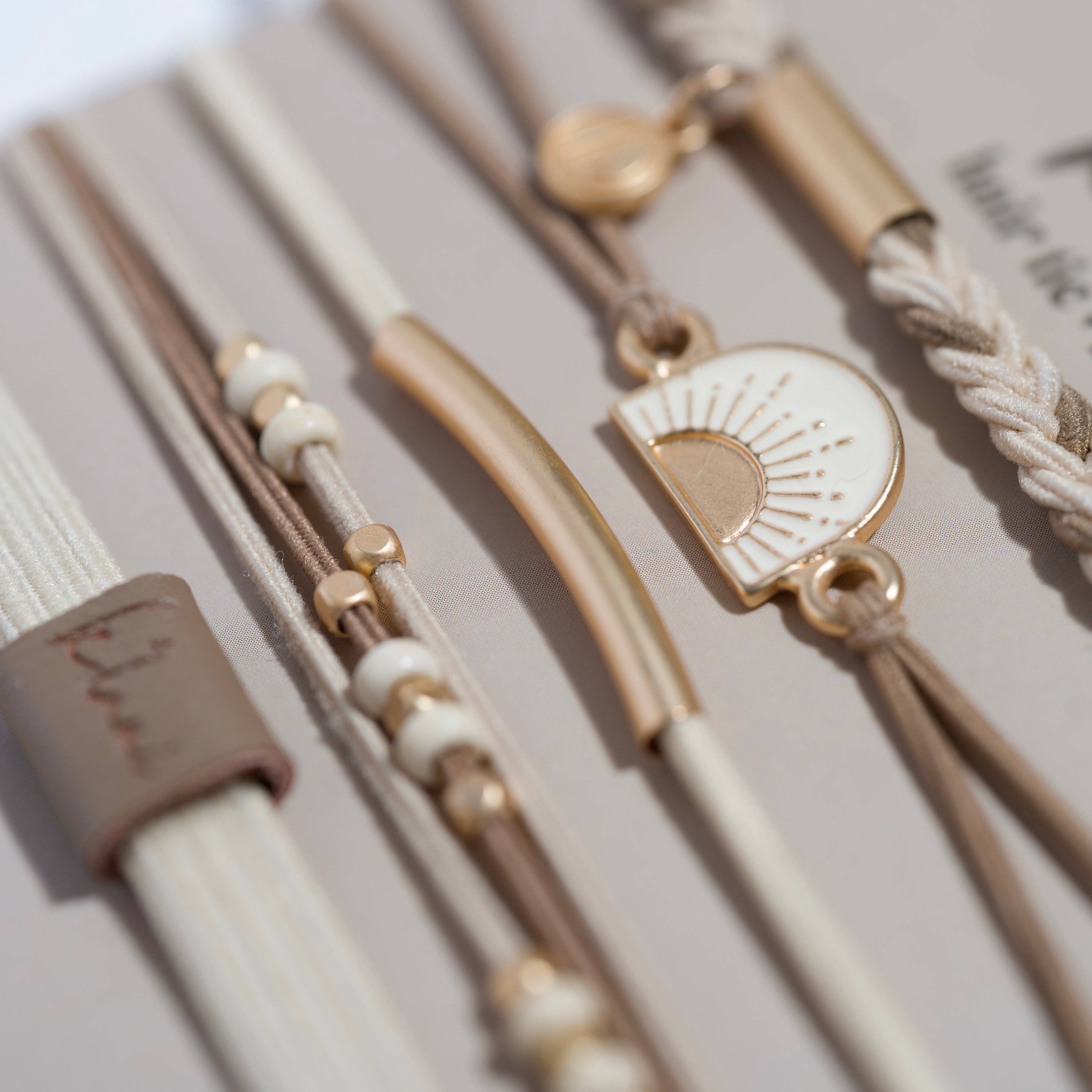 Rise hair tie bracelet set in cream and tan with gold sunrise charm, view 3
