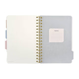 Spiral-bound art journal with a painted iris cover, interior pages