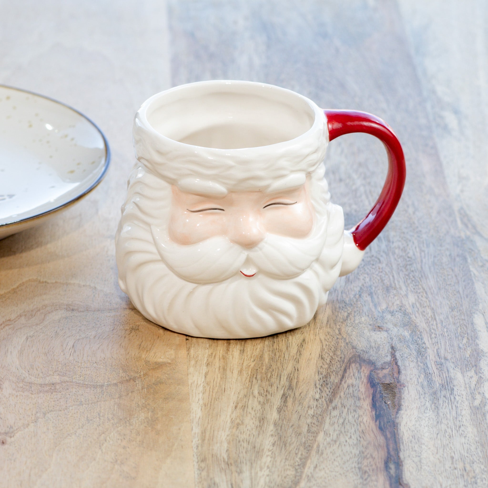 Cream ceramic Santa face mug with red handle