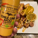 Chile Lime Aioli squeezed over a seafood boil with corn, potatoes and sausage