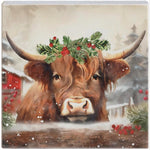 Small square block sign of a Highland cow in a holly crown beside a red barn