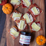 Crackers with apple slices and melted brie topped with Cranberry Relish with Grand Marnier