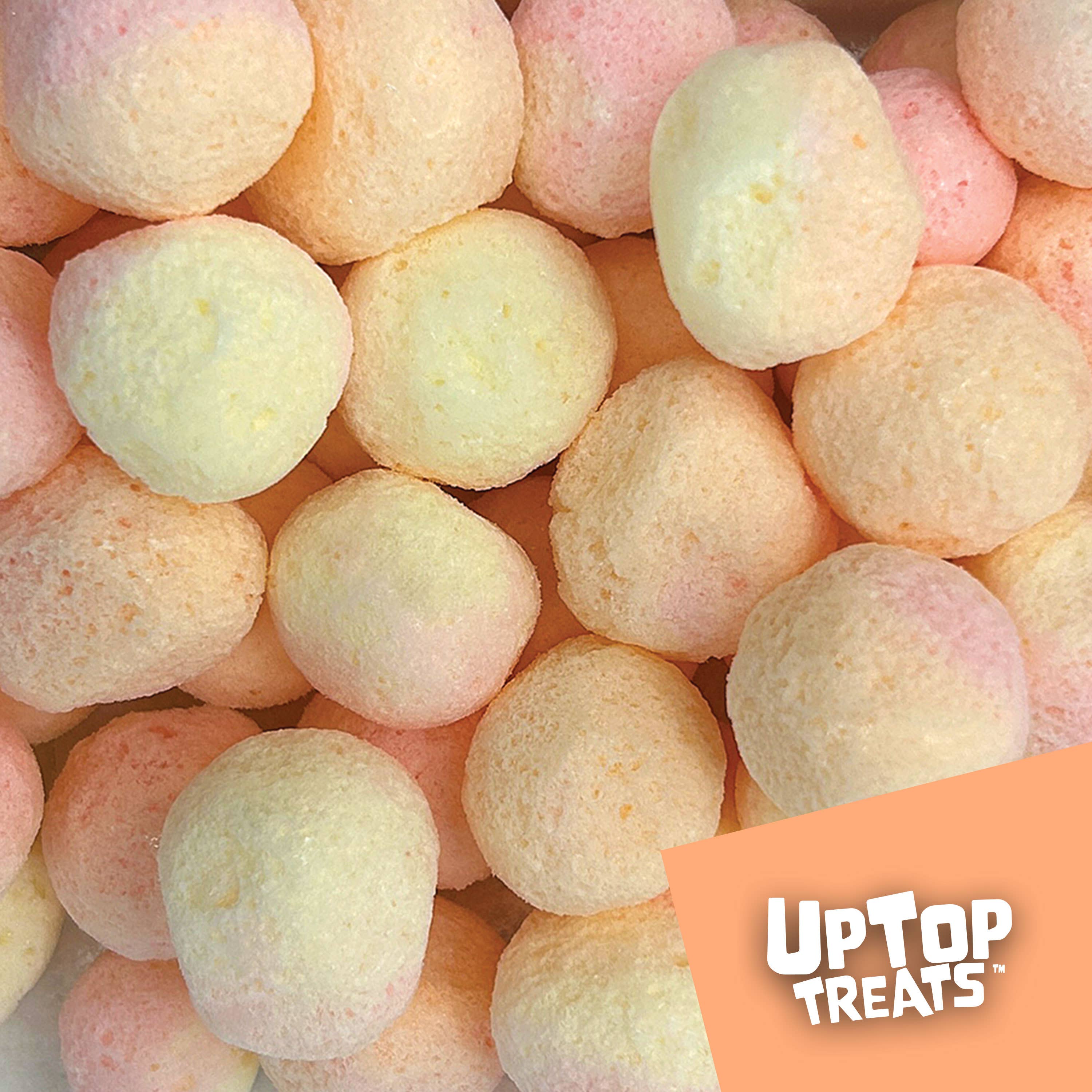 Close up of puffed peach freeze dried candy pieces from UpTop Treats