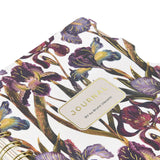 Spiral-bound art journal with a painted iris cover, detail view
