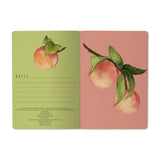 A5 ruled notebook with a painted peach and foliage cover design, detail view