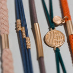 Discover hair tie bracelet set in orange, green, blue and brown with gold pine tree charm, view 3