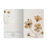 A5 ruled notebook with a blush and gold floral cover design, detail view
