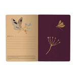 A5 soft-touch notebook with a dark floral and butterfly cover design, interior ruled pages