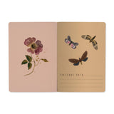 A5 soft-touch notebook with a dark floral and butterfly cover design, detail view