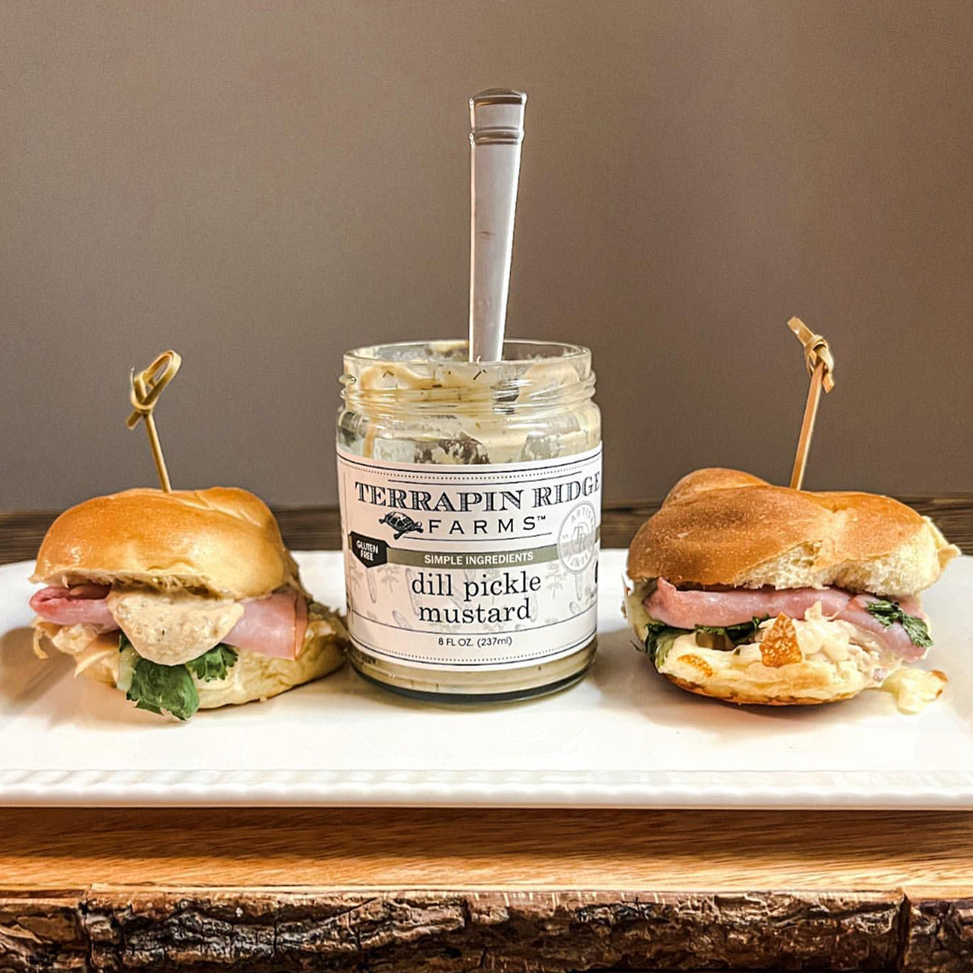 Ham and cheese sliders with an open jar of Dill Pickle Mustard