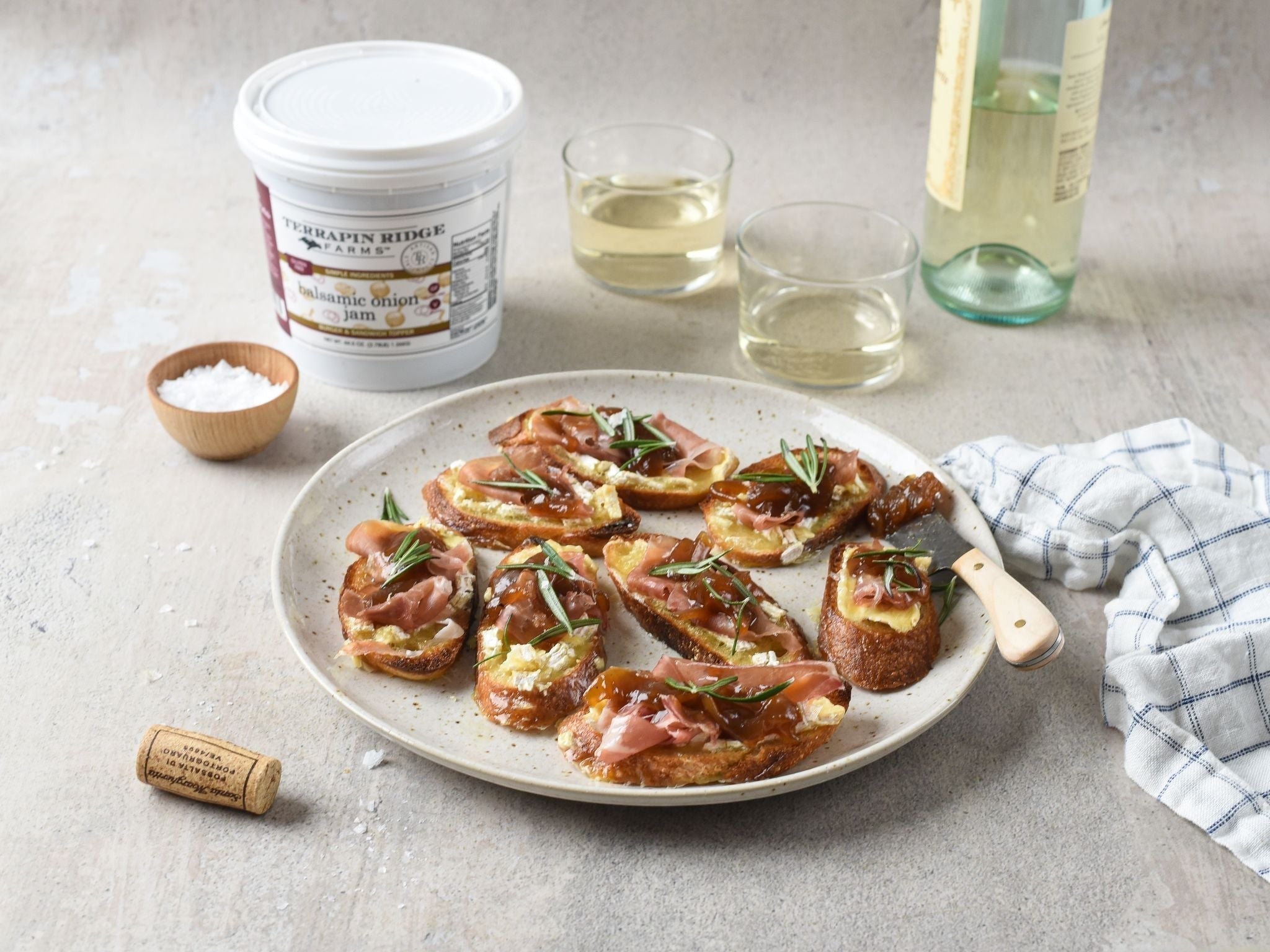 Prosciutto and cheese crostini with white wine and Balsamic Onion Jam