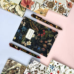 A6 passport-size pocket notebook with a Forest Flowers cover, interior ruled pages