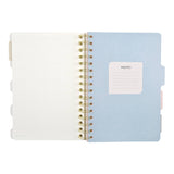 Spiral-bound art journal with a painted iris cover, interior pages