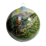 Glass ball ornament painted with two hikers with backpacks on a mountain trail lined with wildflowers