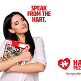 Woman hugging a boxed jigsaw puzzle, gift idea for puzzle lovers
