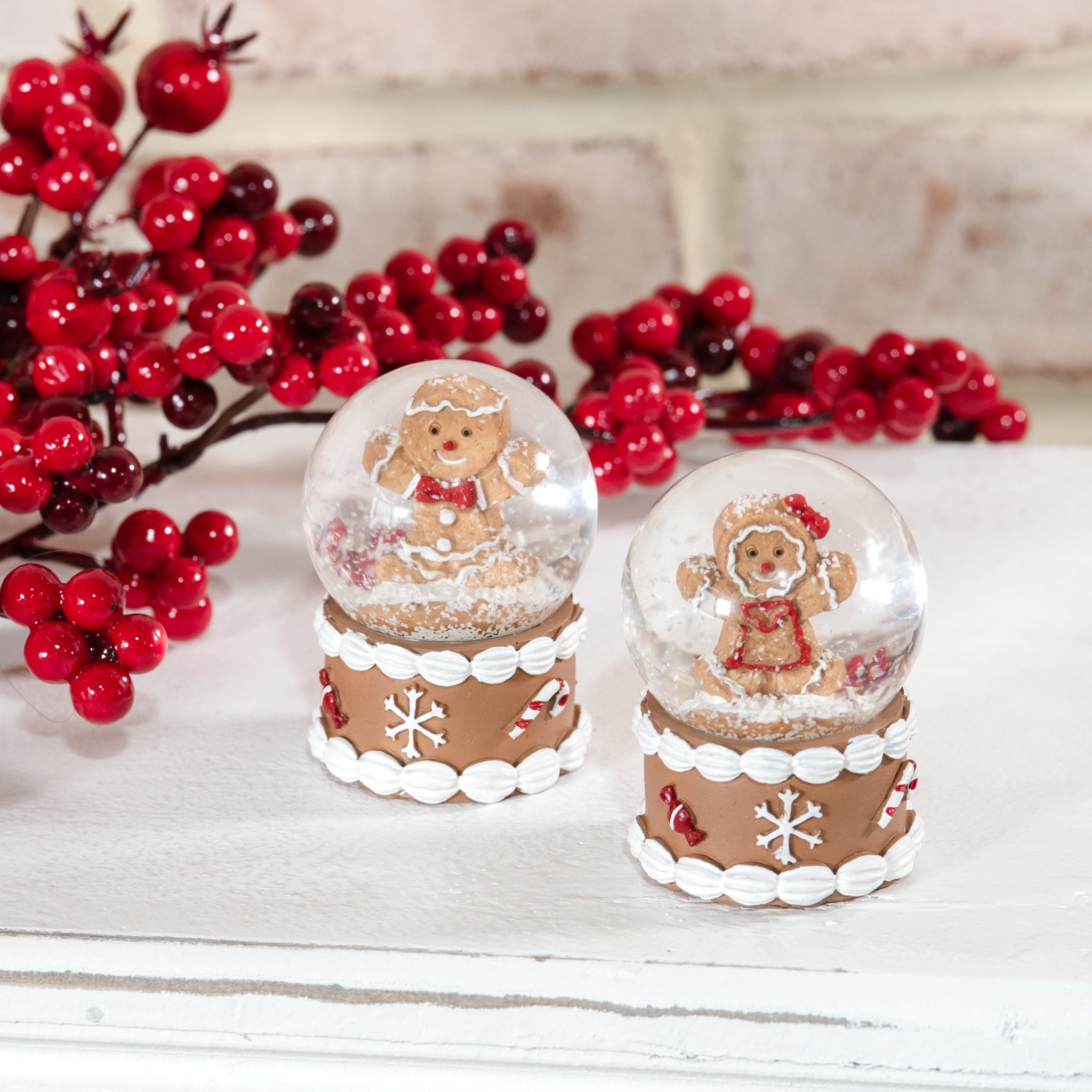 Two gingerbread mini snow globes with iced bases