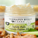 Open jar of Hatch Chile Cream Cheese Dip with pretzels