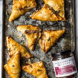 Golden baked pastry triangles filled with Hot Pepper Berry Bacon Jam