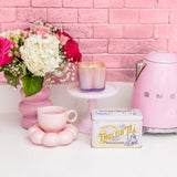 Bridgewater Sweet Grace iridescent flower candle styled on a kitchen counter with flowers and a tea tin