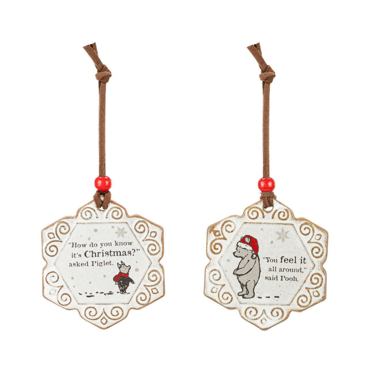 Two scalloped stoneware ornaments with Pooh and Piglet art and a quote, on brown cords with red beads