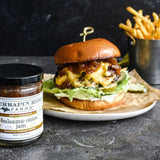 Cheeseburger and fries with a jar of Balsamic Onion Jam